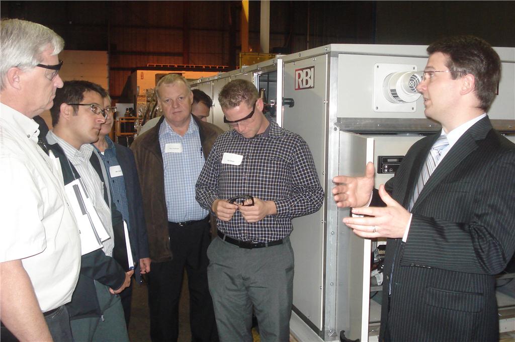 Eric Irmscher (r), sales and application engineer with Mestek, Inc., explains the standard arrangements available with its outdoor air handlers.