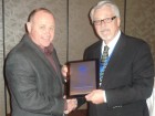 Wayne Bingle (r) accepts a lifetime service award from John Hammill, CIPH chairman of the board.
