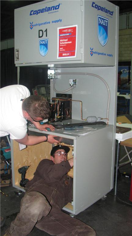 Scheideman hangs an evaporator on a freezer at the 2012 Alberta skills competition.