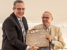 Tyler Stone (l), director of operations presents a commemorative plaque to Timothy Horne, who took over the reins of the company in 1978 until his retirement in 2002. It was under his leadership that the company went public and began the acquisition program that established Watts as an international presence. Photo ImagesPlus Photography