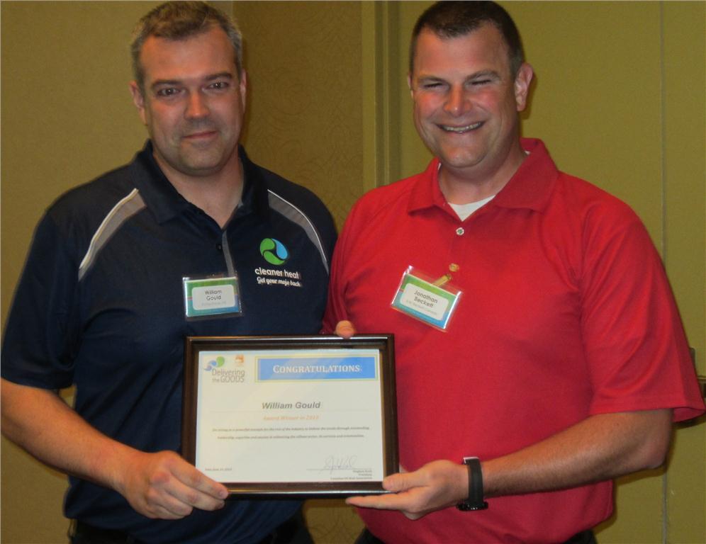 William Gould (l) accepts his "Delivering the Goods" award from Jonathan Beckett director of sales and marketing at R.W. Beckett Corporation.