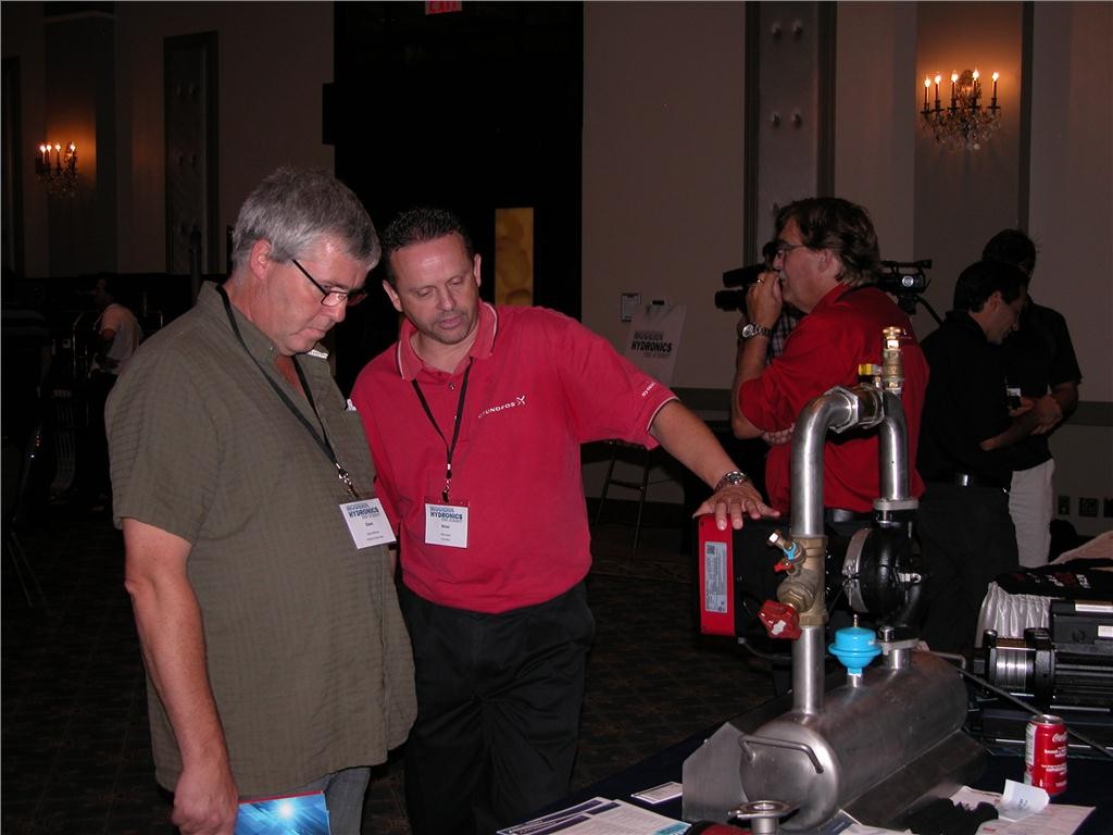 Brian Spry (r) of Grundfos explains the Magna3 to Dave Williams of Williams Kool Heat. The pump was launched a few months ago and features FlowLimit and FlowAdapt functions, as well as having a heat energy meter built into it.