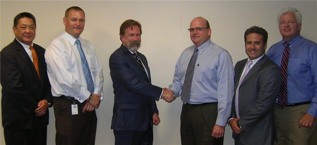 (L) David Krakoff, TOTO president of sales for the Americas, seals the two companies' new partnership with a handshake from Paul Kennedy, Wolseley Canada vice-president of plumbing. (L-R) They are flanked by James Chou, TOTO senior director for Canada; Barry Moulsdale, Wolseley Canada director of strategy and development for plumbing; Michael Bancheri, TOTO district sales manager for Canada; Jeff Cash, Wolseley Canada director of business development.