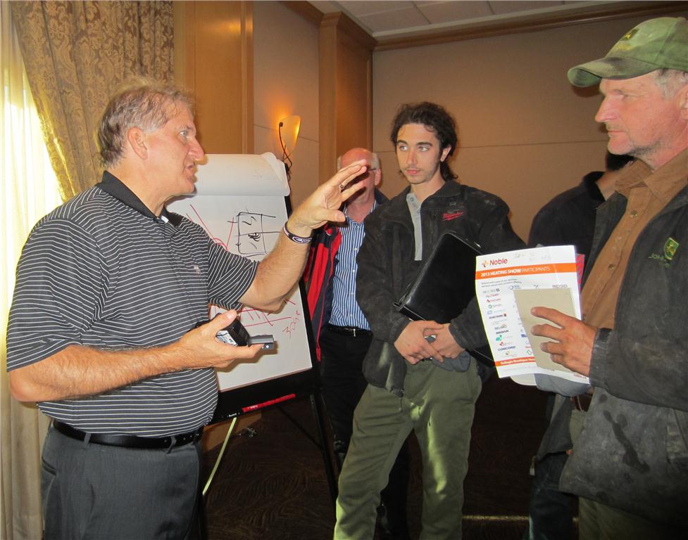 John Barba, trainer from Taco, answers questions about hydronic systems with attendees following his seminar.
