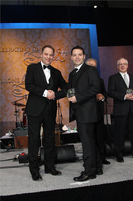 Mario Caissie (r), president of Imperial Manufacturing Group accepts the gold standard award from Frank Vettese, managing partner and chief executive of Deloitte in Canada.