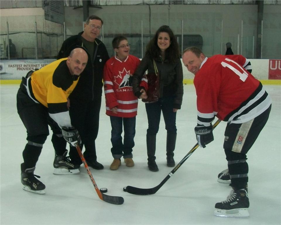 (Left to right) Wolseley employees Bill Hillier, Bill Teabo, Bill Freshwater (far right) on the ice for the ceremonial puck drop by Special Olympian Alex (with his mother). Alex also handed out trophies to the winning team.