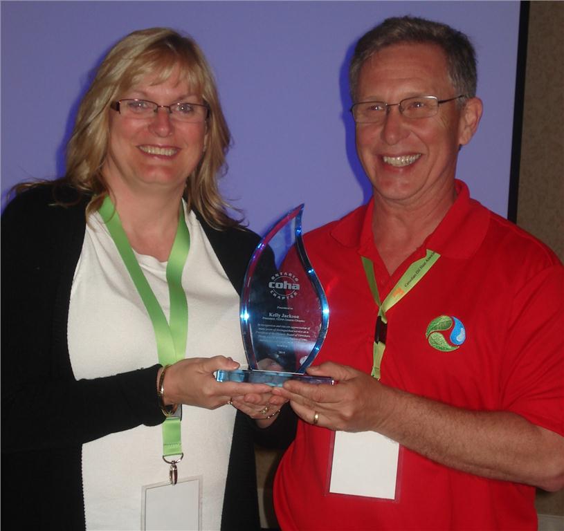 Kelly Jackson (l) accepts a plaque in recognition of her commitment to COHA ON Chapter from Stephen Koch, COHA president. The new executive of the ON board will be named in September.