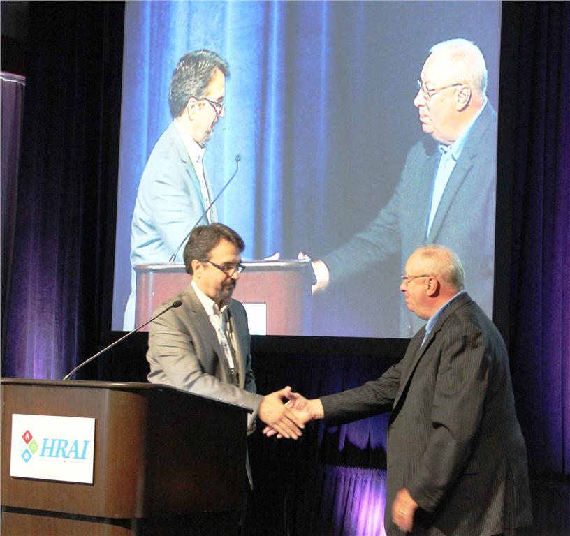 Incoming HRAI chair Jim Flowers welcomes breakfast speaker Jack Demers, retired NHL coach, to the stage. Demers spoke about how he overcame adversity and shared his insights on how others might do the same.