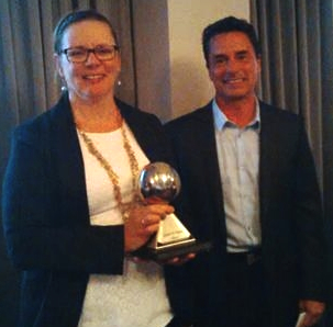 France Lemieux accepts the 2014 Joseph K. Seidner Award from Plumbing Industry Advisory Council chairman Kevin Ernst of OS&B.