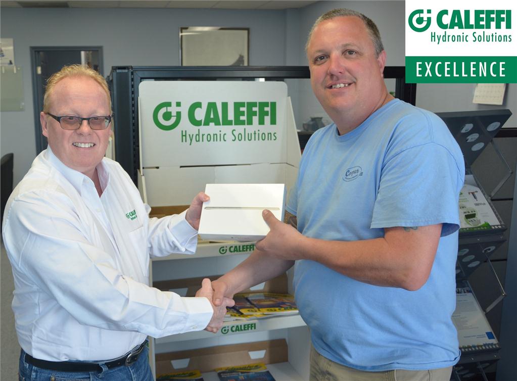 Kim Butts (l) of Mechanical Systems 2000 presents an iPad mini to Jamie Whitehead of Cooper Plumbing and Heating.