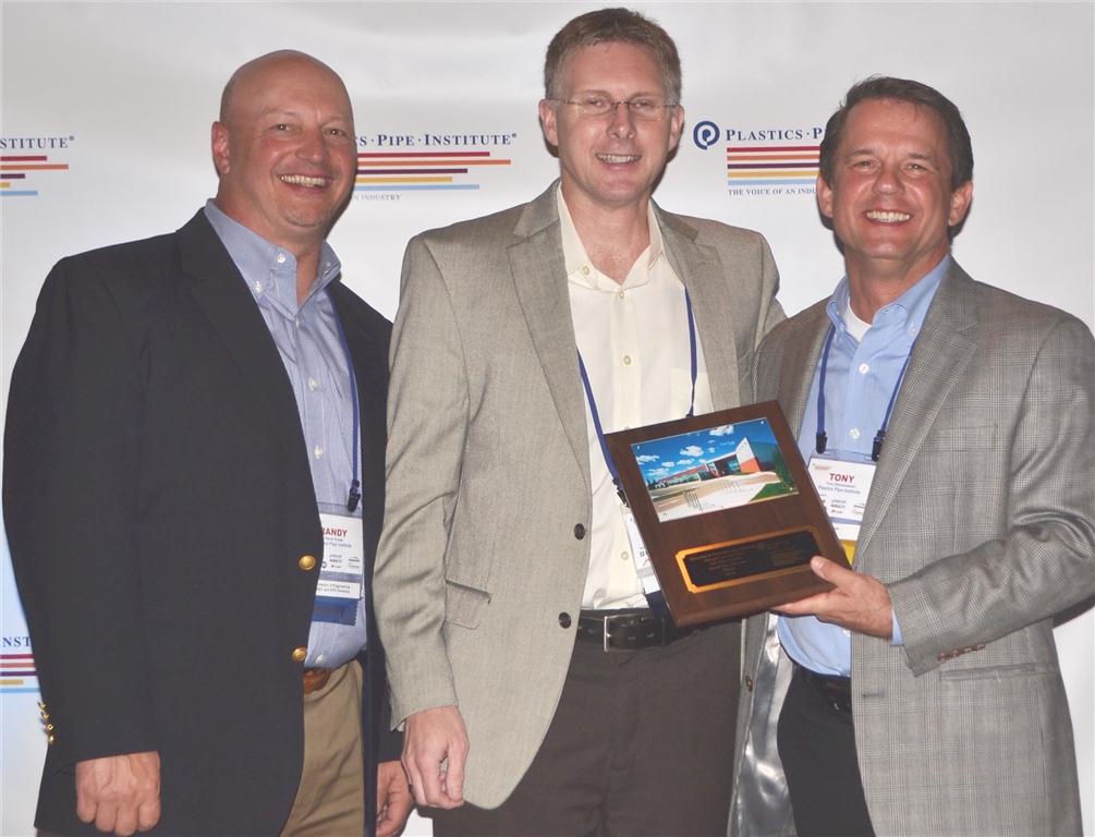 Lance MacNevin of REHAU accepts the project of the year award from PPI's Randy Knapp, director of engineering, building and construction division (left) and Tony Radoszewski, president (right).