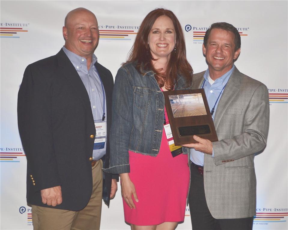 Kate Olinger of Uponor North America receives the PPI Project of the Year Award from PPI's Randy Knapp, director of engineering, building and construction division (left) and Tony Radoszewski, president (right).