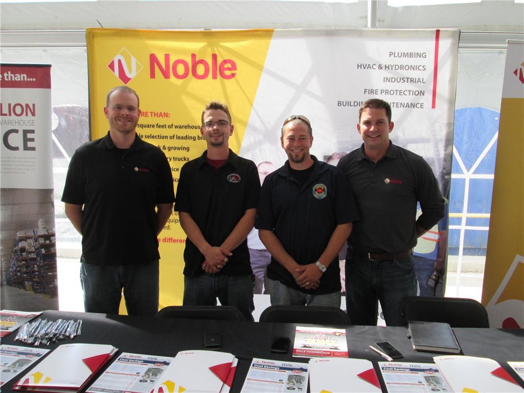 Matthew Rae (far left) and Jason Douglas (far right) of Noble's industrial department man the company's booth at the trade show. They flank 2014 International UA competition champ (HVAC/R) Tyler Radkowski and Derek Sisera, 2013 International UA champ (HVAC/R). Both are from Local 787.