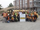 Joe Di Ilio, president, Stanley Black & Decker Canada (centre left) and Liz Etsell (centre right), volunteer site coordinator for Habitat for Humanity GTA, with the Dewalt participants in the Habitat for Humanity Adopt-a-Day Challenge GTA.