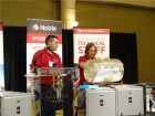 Tom Breen, Noble HVAC Sales Manager - Toronto Region prepares to announce the winners of the prize draw while Ulyana Fedyna, Noble marketing manager, HVAC & Hydronics, spins the drum.
