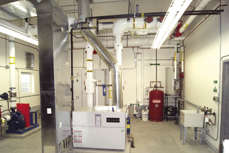 The mechanical room at Seabreeze Dairy Farm. Using VFD pumps, a one million Btu boiler supplies heating to the three tanks. The system, which is a primary/secondary heating system, maintains a constant 98C to the hydrolyzer, liquid and digester tanks. The tanks all have a mix of wall and infloor heat. The system is designed to maintain the digester of 2500 m3 at 40C, hydrolyzer (260 m3) at 25C and liquid tanks (200 m3) at 15C.