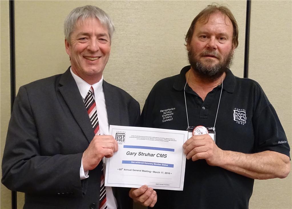 Gary Struhar (r) accepts a certificate for achieving Honorary Member Status from Denis Hebert.