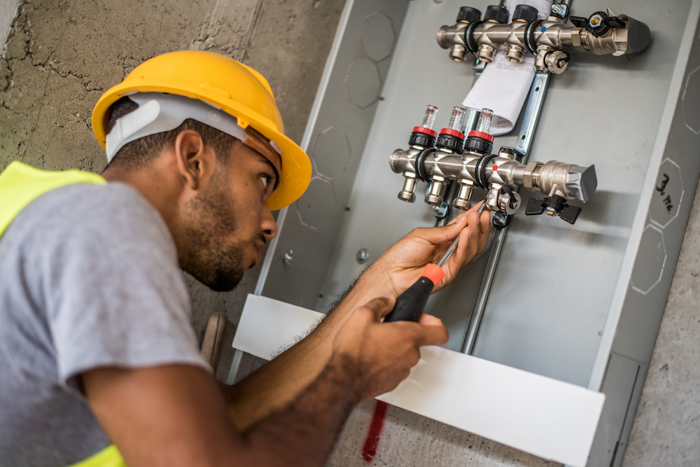 Construction worker configuring water valves